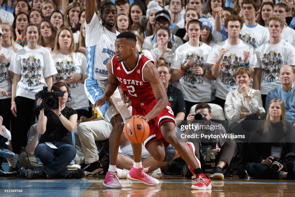 Torin Dorn of the North Carolina State Wolfpack dribbles the ball ...