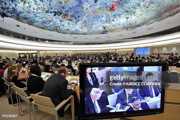 Representatives attend the United Nations Human Rights Council session under a painting on the ceiling by Spanish artist Miquel Barcelo on September...