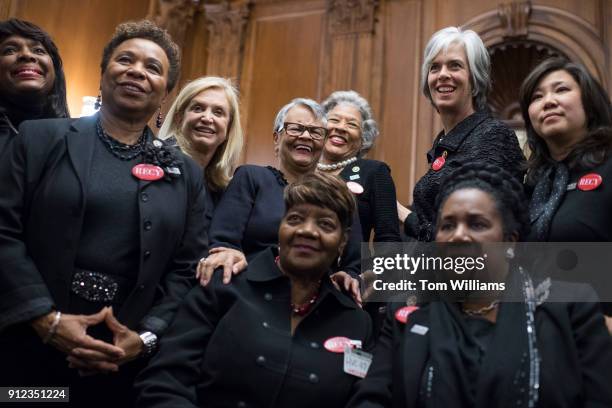 Rose Gunter, front and center, the niece of sexual assault survivor Recy Taylor, wears black during a photo op in the Capitol's Rayburn Room to show...