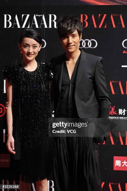 Chinese actress Jue Chow and actor Aloys Chen pose on the red carpet prior to a Bazaar charity event on September 28, 2009 in Beijing, China.