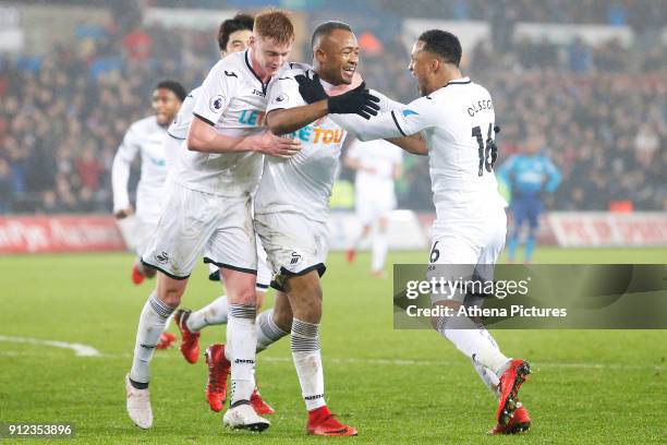Jordan Ayew of Swansea celebrates scoring his sides second goal of the match with team mates Sam Clucas and Martin Olsson during the Premier League...