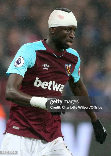 Cheikhou Kouyate of West Ham, head bandaged due to an earlier injury during the Premier League match between West Ham United and Crystal Palace at...