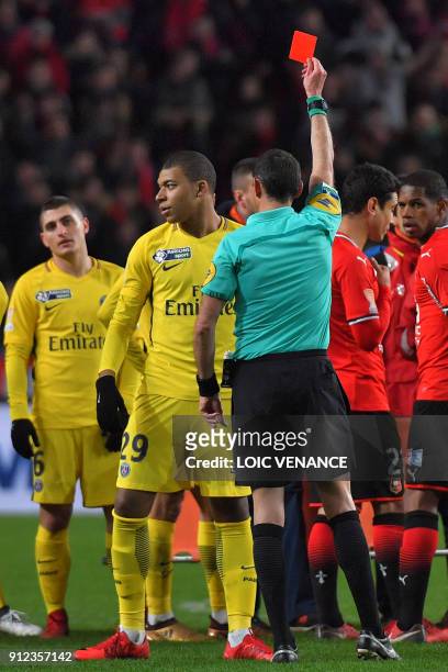 Paris Saint-Germain's French forward Kylian Mbappe reacts as the referee gives him a red card during the French League Cup football semi-final match...