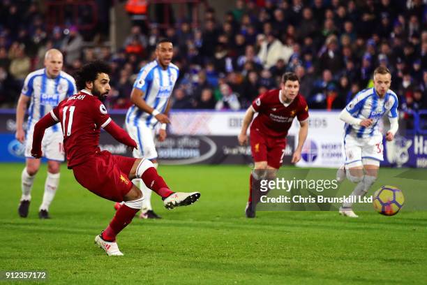 Mohamed Salah of Liverpool scores his side's third goal from the penalty spot during the Premier League match between Huddersfield Town and Liverpool...