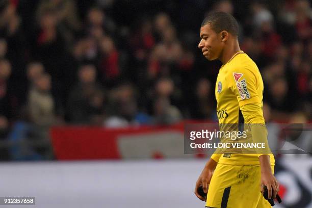 Paris Saint-Germain's French forward Kylian Mbappe reacts as he leaves the football pitch after receiving a red card during the French League Cup...