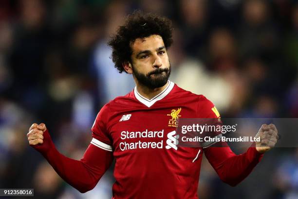 Mohamed Salah of Liverpool celebrates scoring his side's third goal from the penalty spot during the Premier League match between Huddersfield Town...