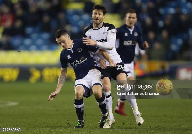 Shaun Williams of Millwall tackles David Nugent of Derby County during the Sky Bet Championship match between Millwall and Derby County at The Den on...