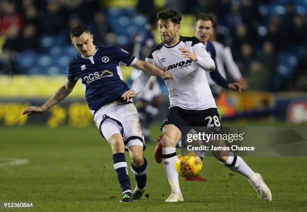 Shaun Williams of Millwall tackles David Nugent of Derby County during the Sky Bet Championship match between Millwall and Derby County at The Den on...