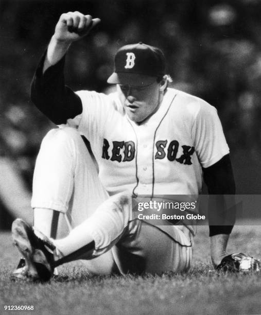 Boston Red Sox Roger Clemens stands up after he hit the ground during the seventh inning of a game against the California Angels at Fenway Park in...