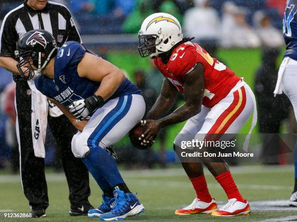 Center Alex Mack of the Atlanta Falcons from the NFC Team hikes the ball to Defensive End Melvin Ingram of the Los Angeles Chargers from the AFC Team...