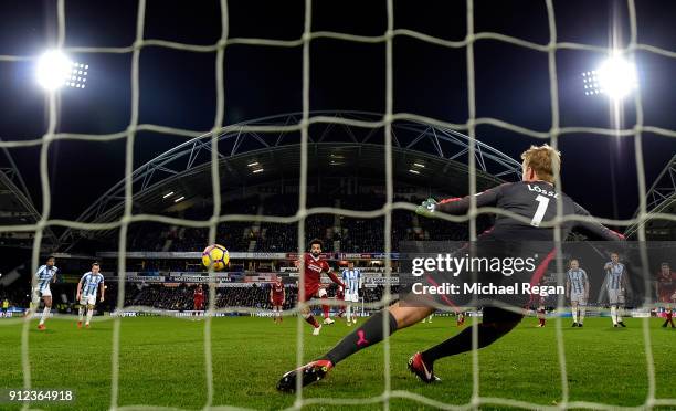 Mohamed Salah of Liverpool scores their third goal from the penalty spot past Jonas Lossl of Huddersfield Town during the Premier League match...