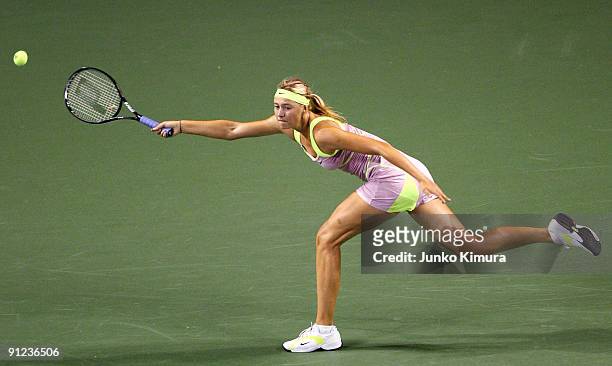 Maria Sharapova of Russia plays a forehand in her match against Samantha Stosur of Australia during the third day of the Toray Pan Pacific Open...