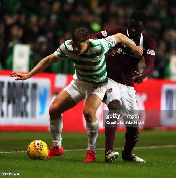 James Forrest of Celtic vies with Prince Buaben of Heart of Midlothian during the Scottish Premier League match between Celtic and Heart of...