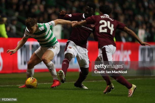 James Forrest of Celtic vies with Prince Buaben of Heart of Midlothian during the Scottish Premier League match between Celtic and Heart of...