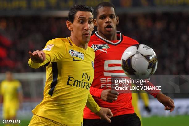 Paris Saint-Germain's Argentinian forward Angel Di Maria and Rennes' French defender Ludovic Baal eye the ball during the French League Cup football...