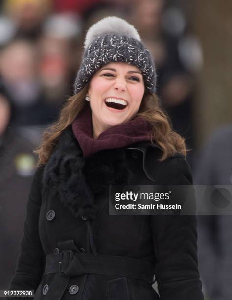Catherine, Duchess of Cambridge reacts after hitting the ball as she attends a Bandy hockey match with Prince William, Duke of Cambridge, where they...