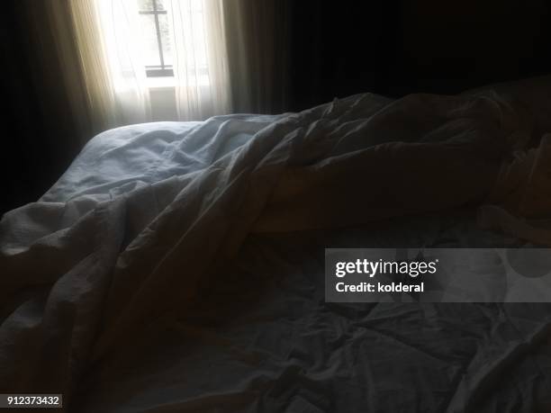 unmade bed early morning. ambient light from window - ambient light stock pictures, royalty-free photos & images