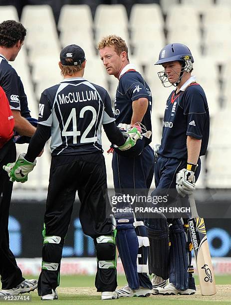 New Zealand's Brendon McCullum talks with England's Paul Collingwood as Eoin Morgan looks on after a run out decision during the ICC Champions Trophy...