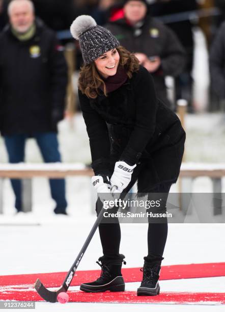 Catherine, Duchess of Cambridge hits a ball as she attends a Bandy hockey match with Prince William, Duke of Cambridge, where they will learn more...