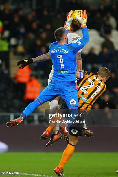 Allan McGregor of Hull City jumps to gather the ball as Pontus Jansson of Leeds United wins the header from Hull City's captain Michael Dawson it...