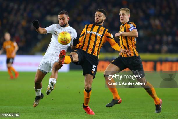 Michael Hector of Hull City wins the ball from Kemar Roofe of Leeds United as Michael Dawson runs in to assist during the Sky Bet Championship match...