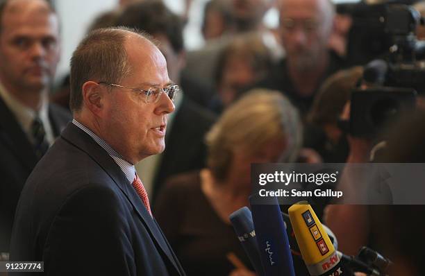 German Finance Minister and member of the German Social Democrats Peer Steinbrueck talks to the media while he takes a break during the first meeting...