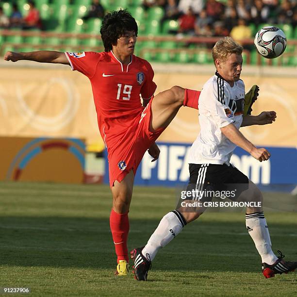 South Korea's forward Bo Kyung Kim kicks high behind German defense Florian Jungwirth during their Group C FIFA U-20 World Cup football match in the...