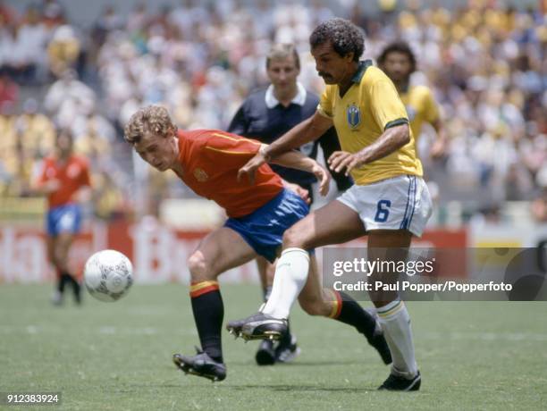 Emilio Butragueno of Spain challenges Junior of Brazil during the FIFA World Cup match between Spain and Brazil at the Estadio Jalisco in...