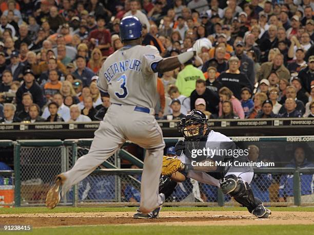 Yuniesky Betancourt of the Kansas City Royals gets ready to slide into home while Gerald Laird of the Detroit Tigers readys to make the tag during...