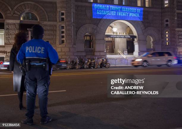 Projection by Artist Robin Bell reading "Donald Trump harassed or assaulted twenty women" is seen on the side of the Trump International Hotel in...