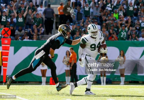 Kony Ealy of the New York Jets runs his interception against Blake Bortles of the Jacksonville Jaguars on October 1, 2017 at MetLife Stadium in East...