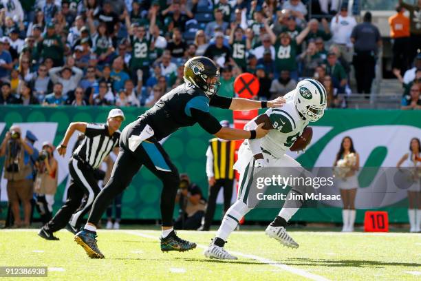 Kony Ealy of the New York Jets runs his interception against Blake Bortles of the Jacksonville Jaguars on October 1, 2017 at MetLife Stadium in East...