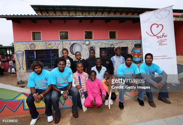 Lasith Malinga , Angelo Mathews , Chamara Kapugedera and Kumar Sangakkara of Sri Lanka pose for a photograph with children during a THINK WISE visit...