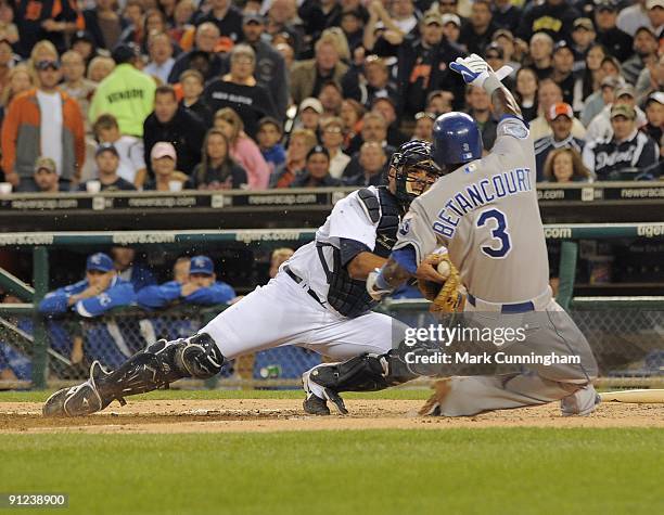 Yuniesky Betancourt of the Kansas City Royals slides into home while Gerald Laird of the Detroit Tigers makes the tag during the game at Comerica...