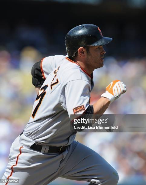 Freddy Sanchez of the San Francisco Giants runs to first base after hitting a single in the first inning against the Los Angeles Dodgers at Dodger...