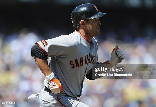 Freddy Sanchez of the San Francisco Giants runs to first base after hitting a single in the first inning against the Los Angeles Dodgers at Dodger...
