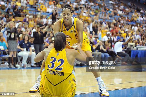 Candace Parker of the Los Angeles Sparks helps up teammate Tina Thompson in Game One of the Western Conference Finals against the Phoenix Mercury...