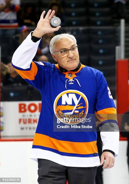 Former New York Islander John Tonelli salutes the fans prior to a game between the New York Islanders and the Florida Panthers at Barclays Center on...