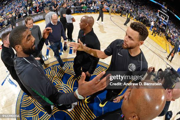 Kyrie Irving of the Boston Celtics and Stephen Curry of the Golden State Warriors exchange a hand shakes prior to the game between the two teams on...
