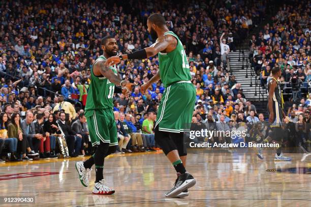 Kyrie Irving and Marcus Morris of the Boston Celtics exchange a hand shakes during the game against the Golden State Warriors on January 27, 2018 at...