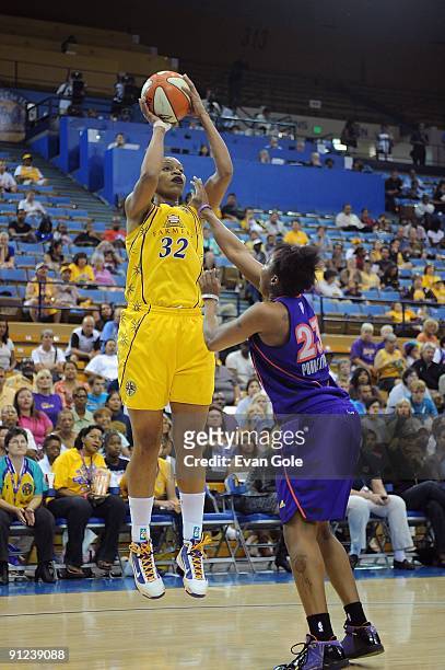 Tina Thompson of the Los Angeles Sparks shoots the ball over Cappie Pondexter of the Phoenix Mercury in Game One of the Western Conference Finals...