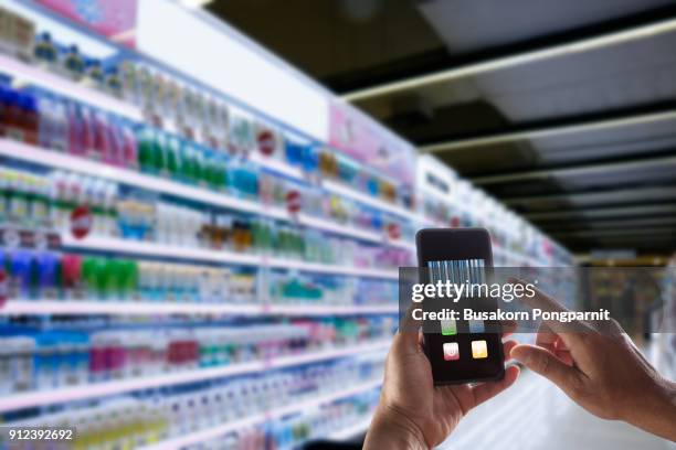 businessman hand holding smartphone and touching barcode on device screen in warehouse distribution - medical scanning equipment stock pictures, royalty-free photos & images