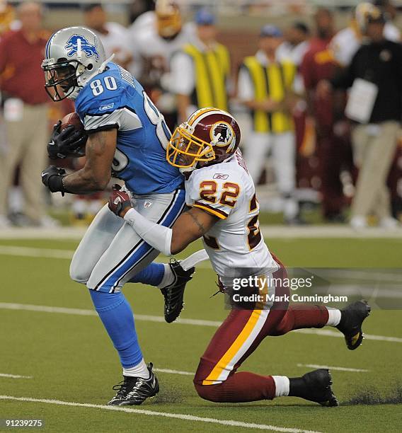 Bryant Johnson of the Detroit Lions is tackled from behind after catching a pass by Carlos Rogers of the Washington Redskins at Ford Field on...