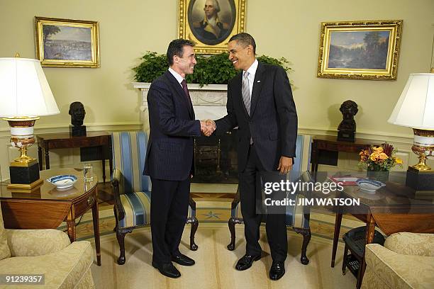 President Barack Obama shakes hands with NATO Secretary General Anders Fogh Rasmussen during a meeting in the Oval Office of the White House in...