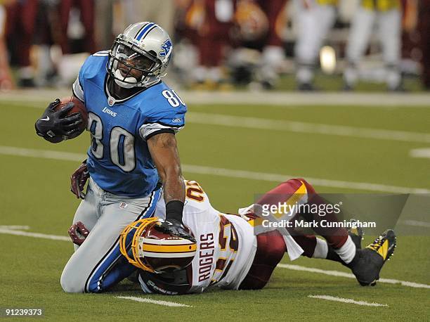 Bryant Johnson of the Detroit Lions is tackled from behind after catching a pass by Carlos Rogers of the Washington Redskins at Ford Field on...