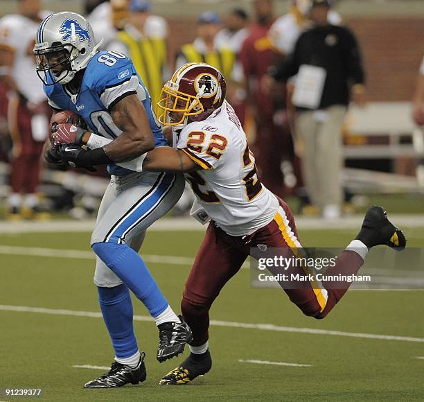 Bryant Johnson of the Detroit Lions is tackled from behind after catching a pass by Carlos Rogers of the Washington Redskins at Ford Field on...