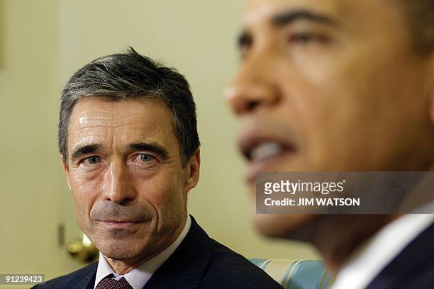 President Barack Obama addresses the media as NATO Secretary General Anders Fogh Rasmussen looks on during a meeting in the Oval Office of the White...