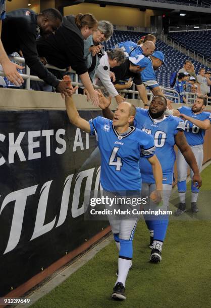 Jason Hanson Grady Jackson and Don Muhlbach of the Detroit Lions shake hands with fans after the victory against the Washington Redskins at Ford...