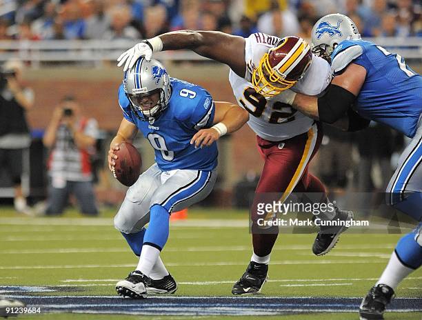 Matthew Stafford of the Detroit Lions tries to elude Albert Haynesworth of the Washington Redskins at Ford Field on September 27, 2009 in Detroit,...