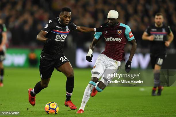 Timothy Fosu-Mensah of Crystal Palace is challenged by Cheikhou Kouyate of West Ham United during the Premier League match between West Ham United...